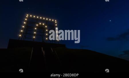 Night shot of the illuminated monument at the top of Spotter's Hill in Hoofddorp, shot from halfway the stairs leading up to the top. Stock Photo