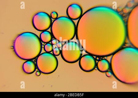 Yellow oil bubbles in a liquid as abstract background Stock Photo