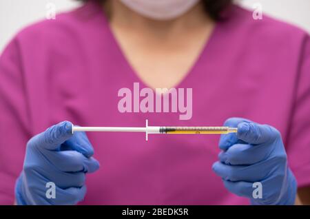 Syringe, medical injection in hand, palm or fingers. Plastic vaccination kit with needle. Nurse or doctor. Liquid or narcotic drugs. Health care in th Stock Photo