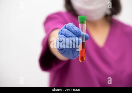Researcher holds test tube with coronavirus virus, analysis and medicine to fight the epidemic. Stock Photo
