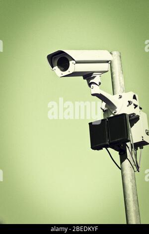 CCTV surveillance camera on pole in street. Stock Photo