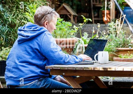 A female consultant doctor working from home during the coronavirus lockdown, London, UK Stock Photo