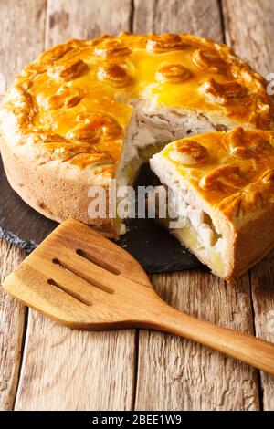 Homemade Russian pie Kurnik with chicken, potatoes and onions close-up on a  slate board on the table. horizontal Stock Photo - Alamy