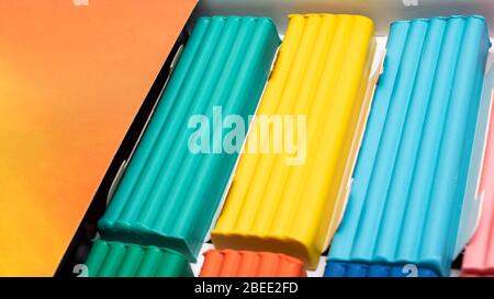 Multi-colored plasticine in a box close-up, background Stock Photo