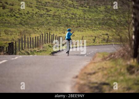 Cumbernauld, UK. 13th Apr, 2019. Pictured: A road cyclist is seen taking a selfie whilst out riding his bike during the Lockdown on a bright and hot sunny Spring Bank Holiday Easter Monday. Due to the UK wide Coronavirus (COVID-19) Lockdown imposed by both the UK and Scottish Governments, police have been enforcing the lockdown and people have been taking the warning seriously with all tourist and beauty hotspots being cordoned off with road blocks. Credit: Colin Fisher/Alamy Live News Stock Photo