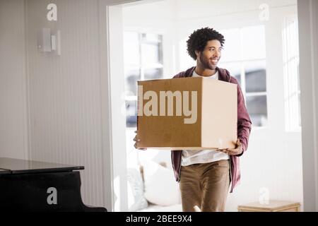 Happy young man moving into a new home Stock Photo