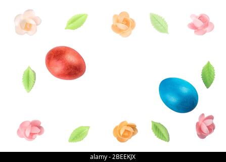 Easter still life with painted eggs and a sweet decor of flowers and leaves. Easter still life isolated on white background with place for text. Flat Stock Photo