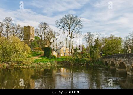 Springtime on the River Great Ouse at Felmersham village bridge in Bedfordshire, UK, overlooked by St Mary's Church Stock Photo