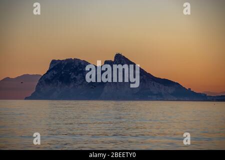 Rock of Gibraltar seen at sunset from Alcaidesa beach in Spain Stock Photo