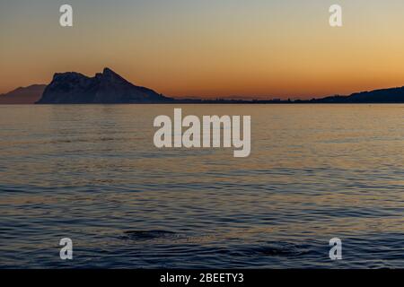 Rock of Gibraltar seen at sunset from Alcaidesa beach in Spain Stock Photo