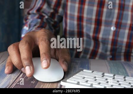 Close up man hand using computer mouse. Stock Photo
