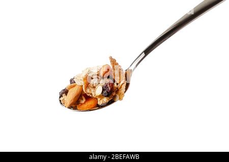 Metal spoon with fiber flakes, oats,almond and dried fruits. Isolated on white background. Stock Photo