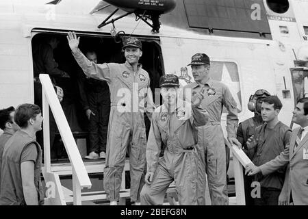 The crew members of Apollo 13, step aboard the USS Iwo Jima, prime recovery ship for the mission, following splashdown and recovery operations in the South Pacific Ocean. Exiting the helicopter, which made the pick-up some four miles from the Iwo Jima are (from left) astronauts Fred W. Haise Jr., lunar module pilot; James A. Lovell Jr., commander; and John L. Swigert Jr., command module pilot. Apollo 13, launched on April 11, 1970, was NASA's third crewed mission to the moon. Two days later, on April 13, while en route to the lunar surface, a fault in the electrical system of one of the Servic Stock Photo