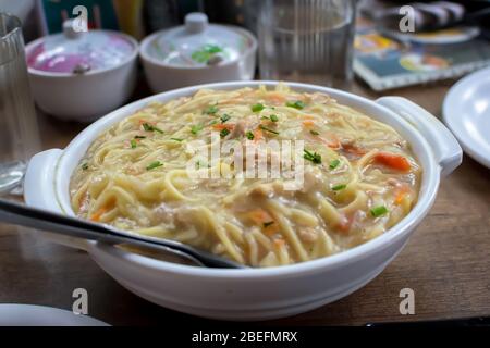 Chicken gravy noodles or chowmein served in a white bowl over moody background. Selective focus Stock Photo