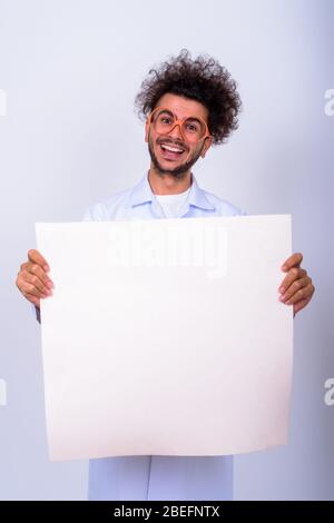 Portrait of funny Turkish man doctor with curly hair holding white board Stock Photo