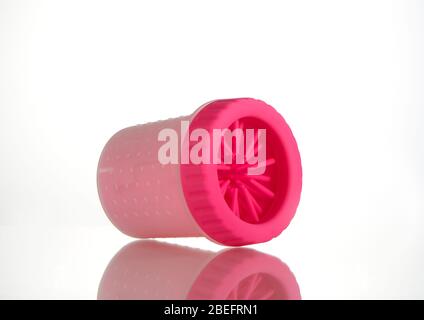 A dog paw cleaner to stop dog diseases and clean the paws of dogs after walks. Photographed on a white background. Stock Photo