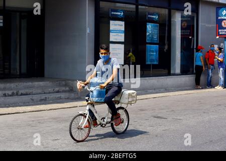Guacara, Carabobo, Venezuela. 13th Apr, 2020. April 13, 2020.A man carries a bottle of drinking water on his bicycle to prepare food and clean himself. The vital liquid is not arriving normally to the pipes of most homes, in the streets of the central town of Guacara, Carabobo state. Photo: Juan Carlos Hernandez Credit: Juan Carlos Hernandez/ZUMA Wire/Alamy Live News Stock Photo