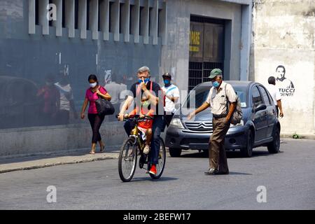 Guacara, Carabobo, Venezuela. 13th Apr, 2020. April 13, 2020. A man travels by bicycle with his little daughter, in the streets of the central town of Guacara, Carabobo state. Photo: Juan Carlos Hernandez Credit: Juan Carlos Hernandez/ZUMA Wire/Alamy Live News Stock Photo