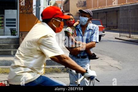 Guacara, Carabobo, Venezuela. 13th Apr, 2020. April 13, 2020. A man walks with his little daughter, in the streets of the central town of Guacara, Carabobo state. Photo: Juan Carlos Hernandez Credit: Juan Carlos Hernandez/ZUMA Wire/Alamy Live News Stock Photo