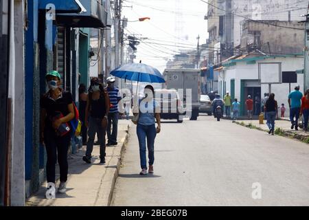 Guacara, Carabobo, Venezuela. 13th Apr, 2020. April 13, 2020. The people walking in front of some closed shops in the streets of the central town of Guacara, Carabobo state. Photo: Juan Carlos Hernandez Credit: Juan Carlos Hernandez/ZUMA Wire/Alamy Live News Stock Photo