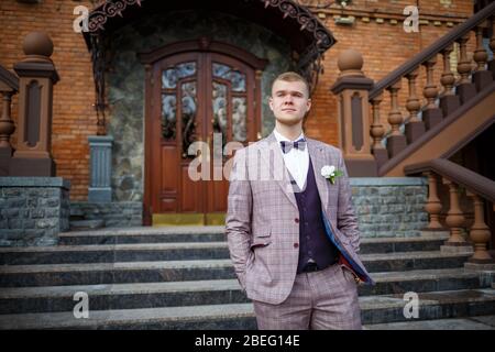 Groom in a beautiful plaid suit and bow-tie Stock Photo