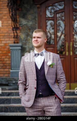 Groom in a beautiful plaid suit and bow-tie Stock Photo