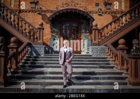 Groom in a beautiful plaid suit and bow-tie Stock Photo