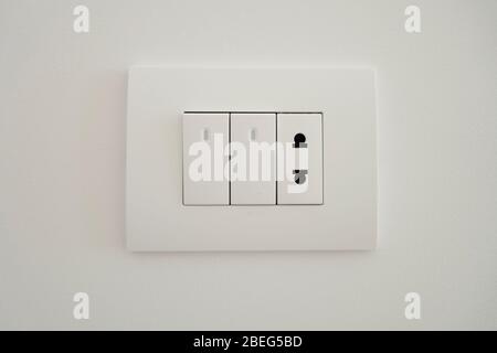 The on-off switch of white color with LED illumination combined with the US standard socket. Stock Photo