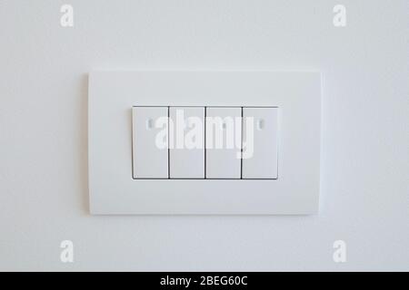 The block of switches from four elements of white color with LED illumination. Stock Photo