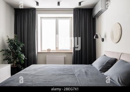 Interior of modern bedroom with light walls Stock Photo