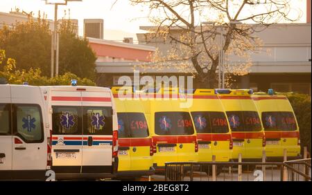 Multiple yellow and white ambulance vans parked in a line in public hospital, Split, Croatia. Bright morning sunrise sky Stock Photo