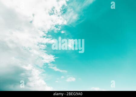 White clouds on mint aqua menthe color sky background Stock Photo