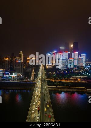 Dec 22, 2019 - Chongqing, China: Aerial night view of Huanghuayuan bridge to Jiang Bei District Stock Photo