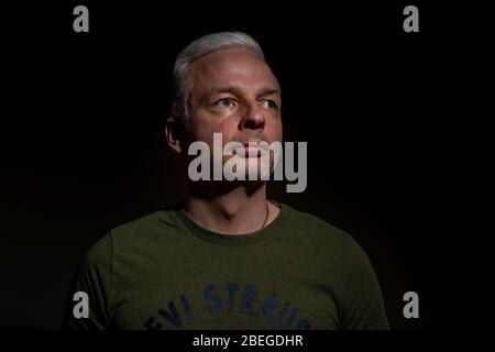 Dramatic closeup shot of white male with one flash setup Stock Photo