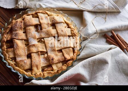 american apple pie and ingredients on wooden background. Top view. Stock Photo