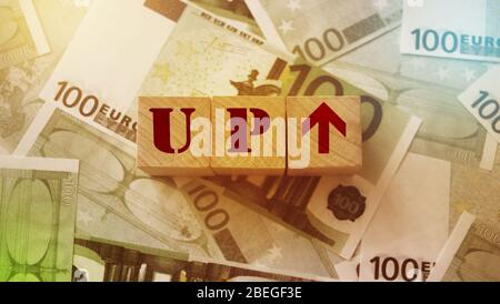 Up and arrow upwards written on wooden cubes. Recovery from crisis trends success strategy solution and business concept Stock Photo