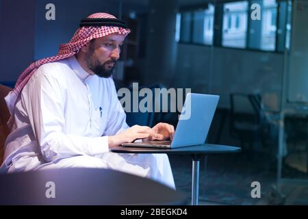 Middle Eastern businessman typing on the phone in his office. Businessman Arabic using mobile phone for connection to communication.Business Technolog Stock Photo