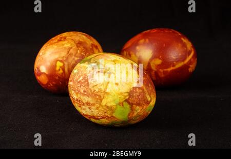 Three traditionally painted Easter eggs isolated on the black background Stock Photo