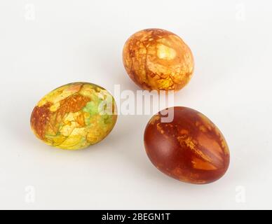 Three traditionally painted brown Easter eggs isolated on the white background Stock Photo