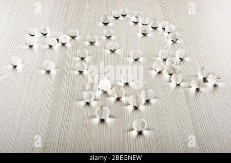 Small transparent glass bubbles on the wooden table Stock Photo