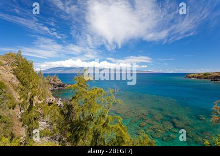 Clear water and coral at Honolua Bay, Maui, Hawaii. Molokai in the distance. Stock Photo