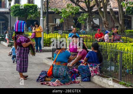 Group of indigenous women selling textiles on  the Central Plaza of Antigua, Guatemala