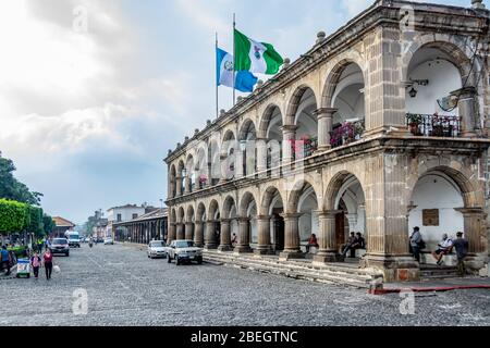 National Guatemalan and Antigua municipal flags flying on top of the Palacio del Ayuntamiento (City Hall Palace) in Antiqua, Guatemala Stock Photo