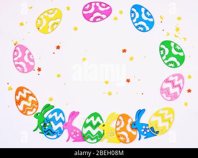 Easter holiday card concept with colored eggs and rabbits on white background with copy space. Happy Easter concept Stock Photo