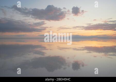 Lake Elton, tranquility scene with mirrored warm tone cloudscape Stock Photo