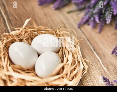 White Easter eggs in the nest. Happy Easter Concept. Congratulations Easter card. Stock Photo