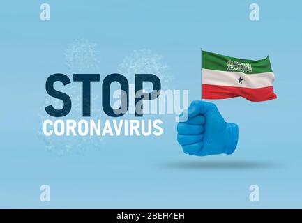 COVID-19 Visual concept - hand-text Stop Coronavirus, hand-gesture versus virus infection, clenched fist holds flag of Somaliland. Pandemic 3D Stock Photo