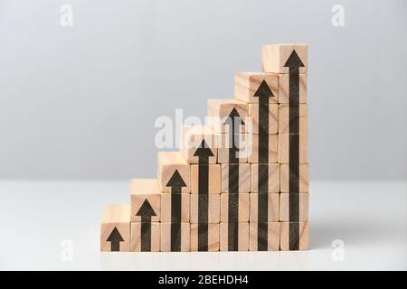 The concept of a successful and growing business is a staircase made of wooden blocks. Close up. Stock Photo