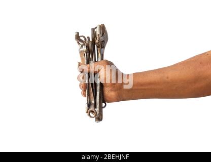 A man holds old and rusty tools for mechanic work on a white background with a path drawing. Stock Photo