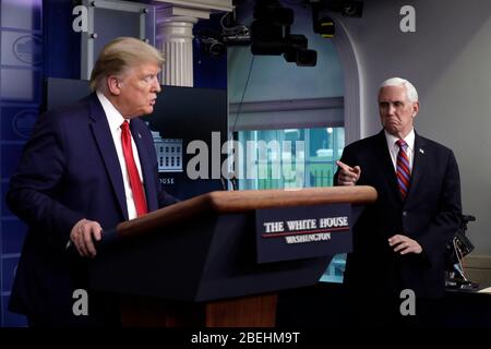 United States Vice President Mike Pence points towards US President Donald J. Trump at the Coronavirus Task Force press briefing at the White House in Washington on April 13, 2020.Credit: Yuri Gripas/Pool via CNP /MediaPunch Stock Photo